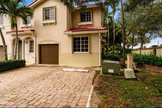 mediterranean / spanish home featuring a garage