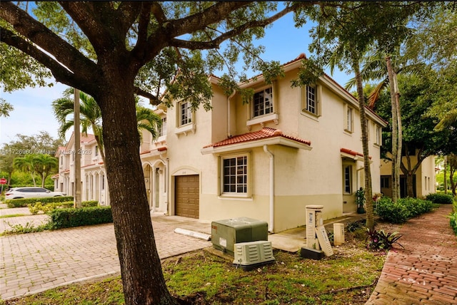 mediterranean / spanish home featuring a garage