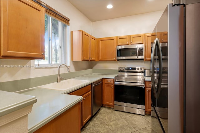 kitchen with light tile patterned floors, plenty of natural light, appliances with stainless steel finishes, and sink