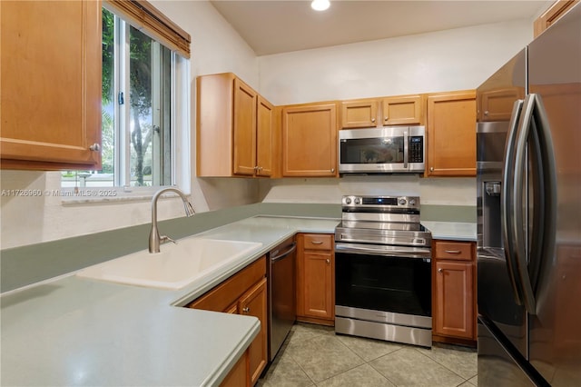 kitchen with light tile patterned floors, sink, and appliances with stainless steel finishes