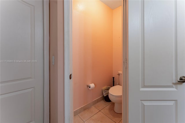 bathroom featuring toilet and tile patterned flooring