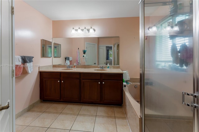 bathroom with shower with separate bathtub, vanity, and tile patterned flooring