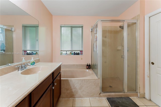 bathroom with tile patterned floors, vanity, and separate shower and tub