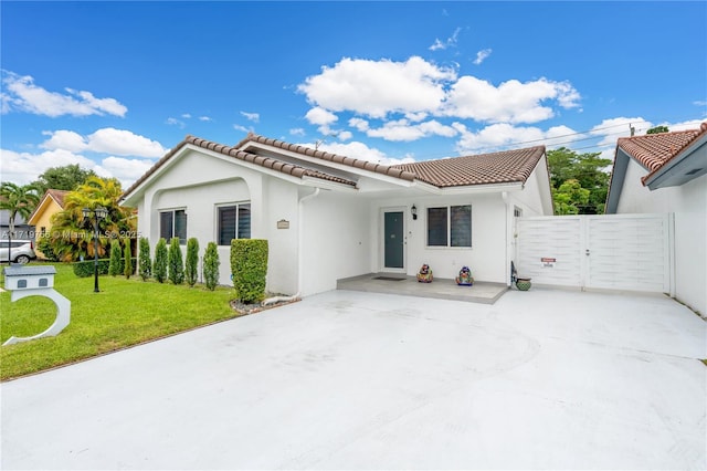 mediterranean / spanish-style home featuring a front yard