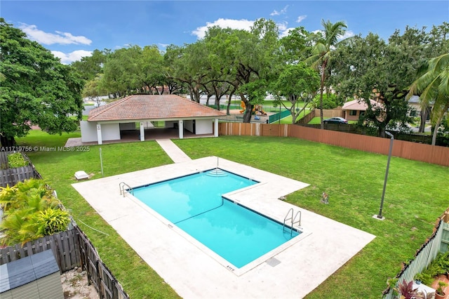 view of swimming pool featuring a lawn and a patio