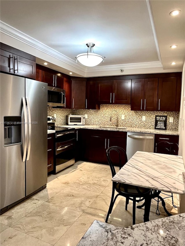 kitchen featuring crown molding, stainless steel appliances, sink, and tasteful backsplash