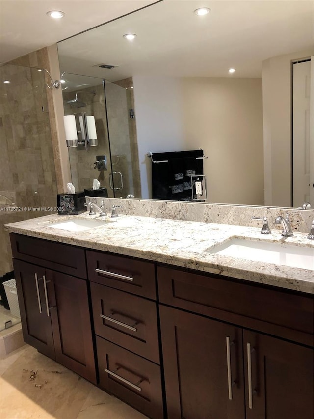 bathroom with an enclosed shower and vanity