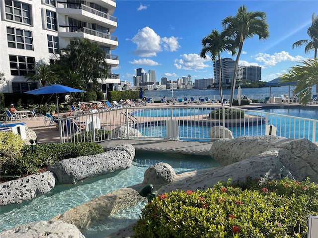 view of swimming pool featuring a water view