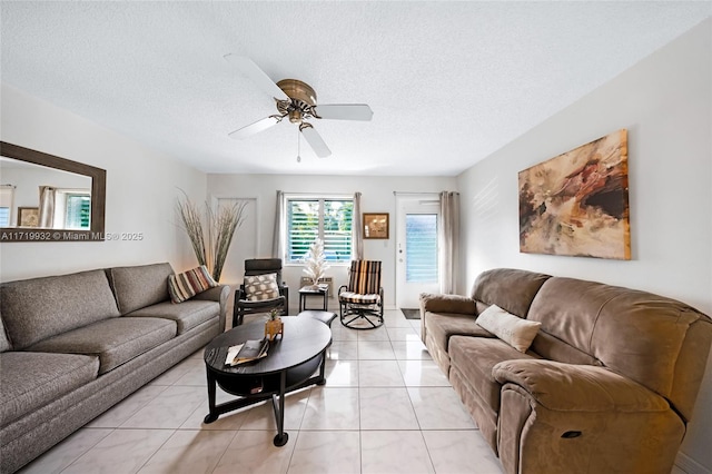 tiled living room featuring ceiling fan and a textured ceiling