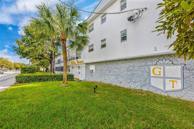 view of property exterior with a lawn