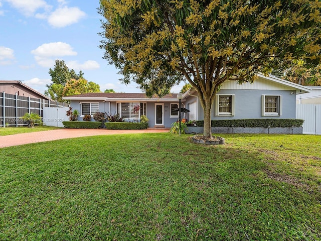 ranch-style home with a front lawn