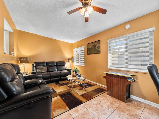 tiled living room with ceiling fan and a textured ceiling