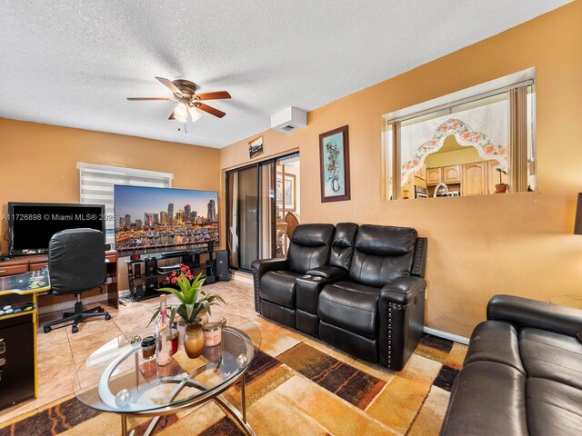 living room with a textured ceiling and ceiling fan