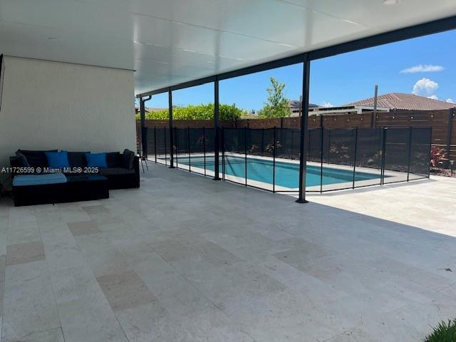 view of pool with an outdoor living space and a patio area