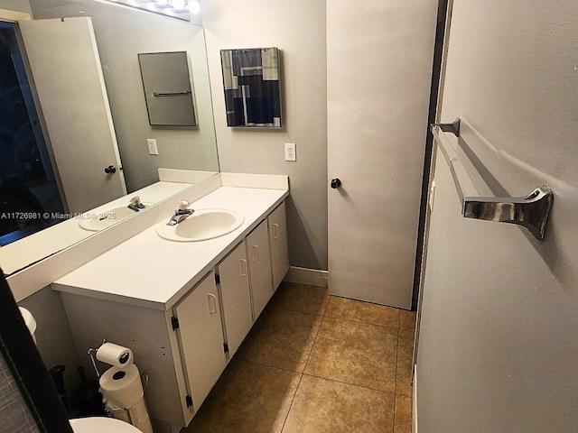 bathroom featuring tile patterned flooring, vanity, and baseboards