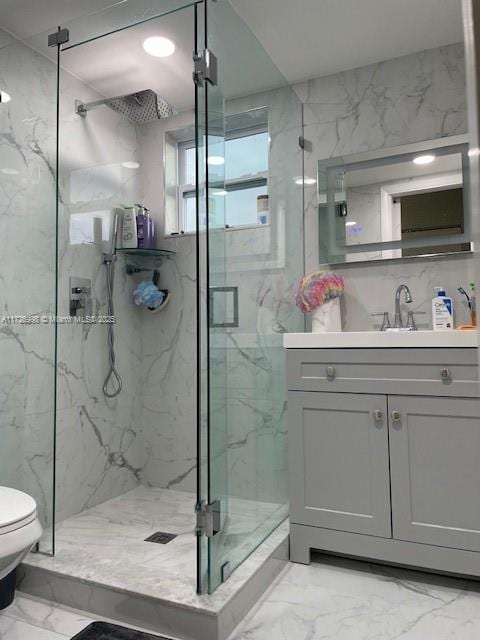 bathroom with toilet, walk in shower, and vanity