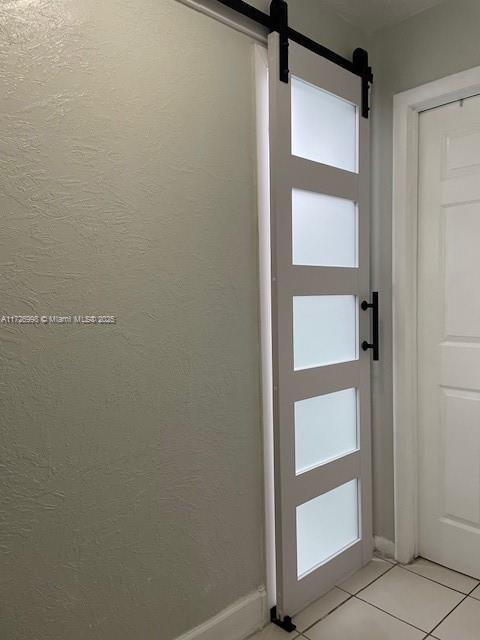 doorway to outside with light tile patterned flooring