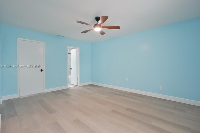 empty room with hardwood / wood-style floors and ceiling fan