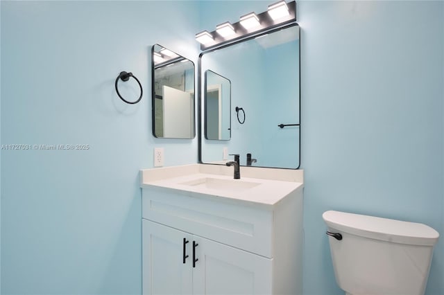 bathroom with toilet and vanity