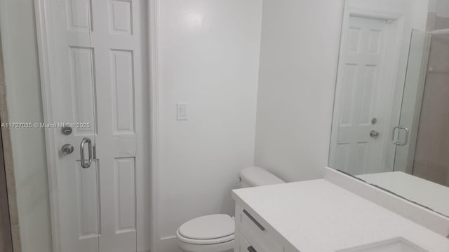 571 SE 37th Pl, Homestead, FL 33033 - bathroom featuring vanity, toilet, and walk in shower