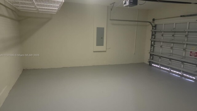 571 SE 37th Pl, Homestead, FL 33033 - garage featuring a garage door opener and electric panel