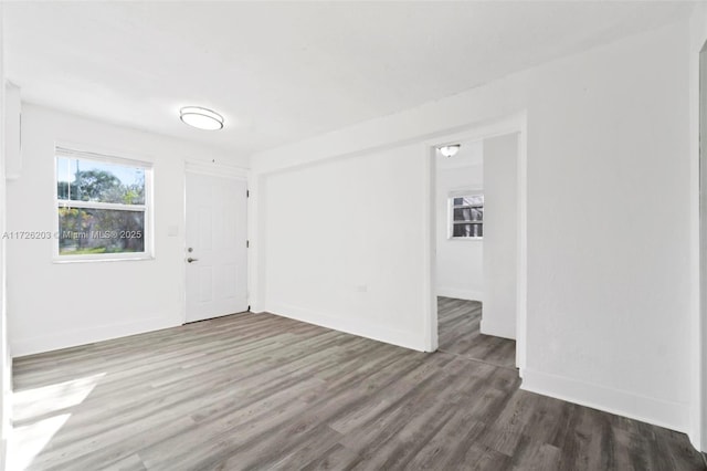 empty room with dark wood-type flooring