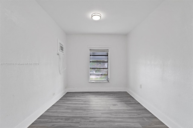 unfurnished room with dark hardwood / wood-style flooring