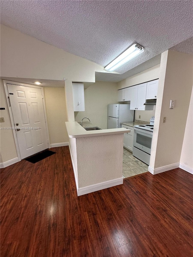 kitchen featuring white appliances, white cabinets, a textured ceiling, sink, and kitchen peninsula