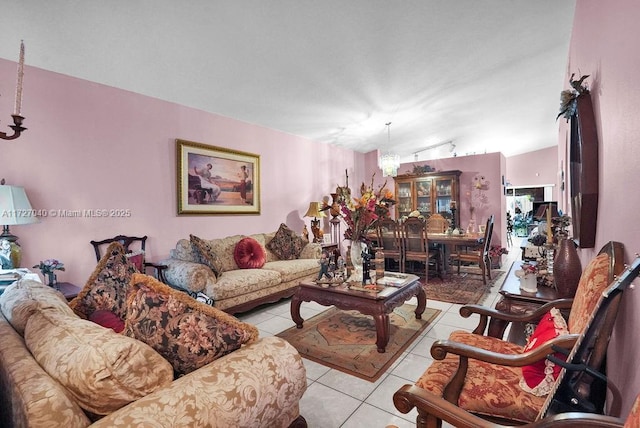 living room with light tile patterned floors, lofted ceiling, and a notable chandelier