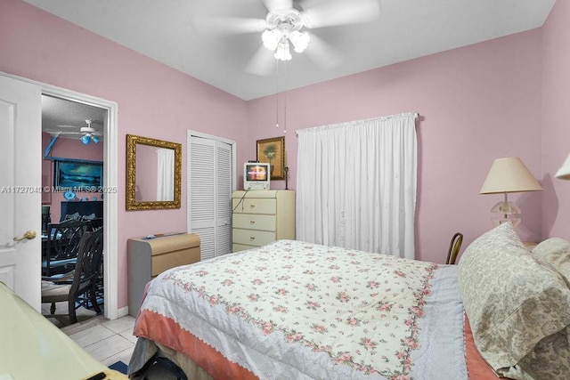 tiled bedroom with ceiling fan and a closet