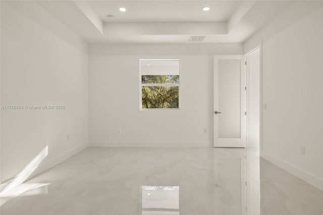 unfurnished room featuring a tray ceiling