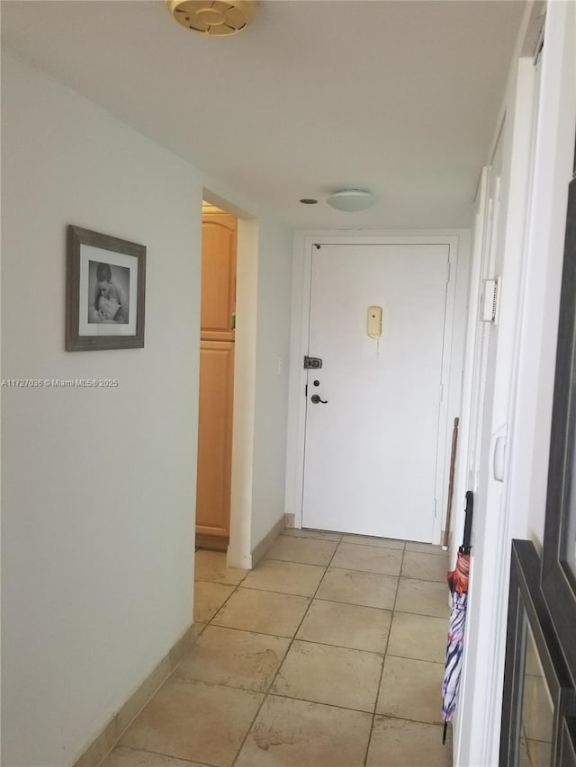 corridor featuring light tile patterned floors