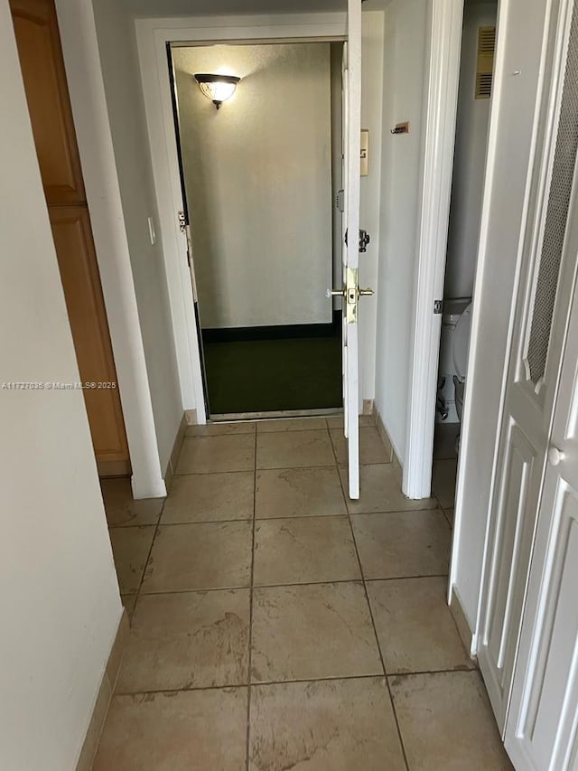 hallway with light tile patterned floors