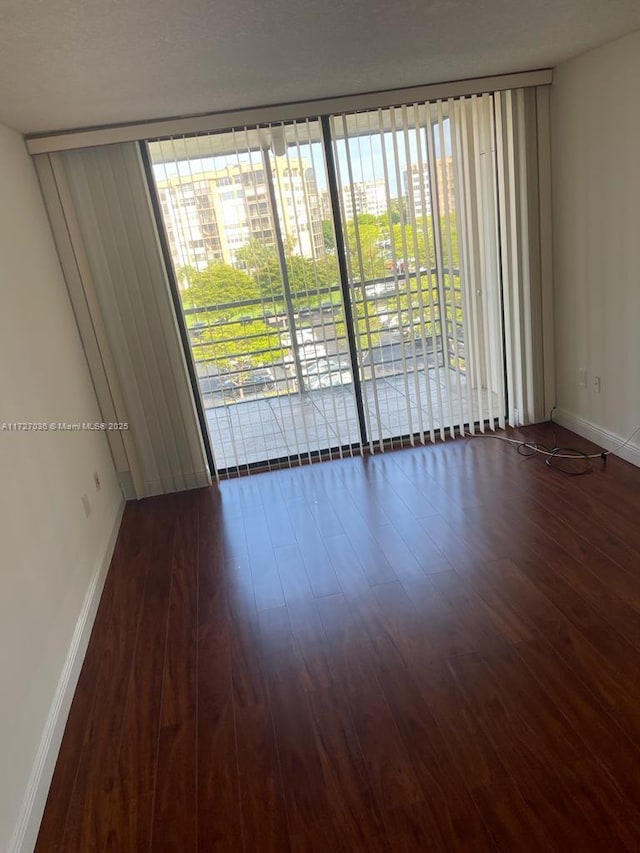 spare room featuring dark hardwood / wood-style floors