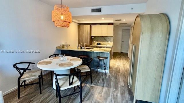 dining area with dark hardwood / wood-style flooring