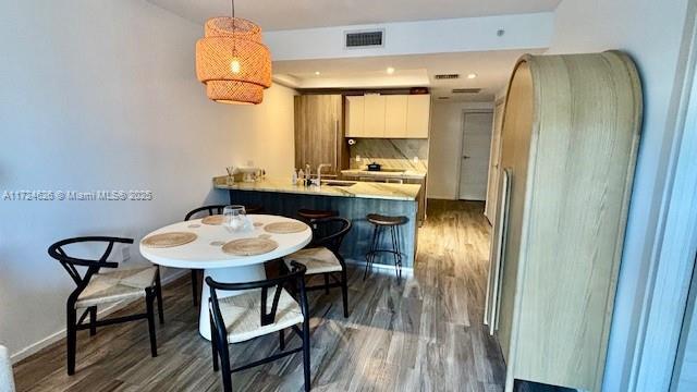 801 S Miami Ave Unit 4706, Miami, FL 33130 - dining area with dark wood-style floors and baseboards