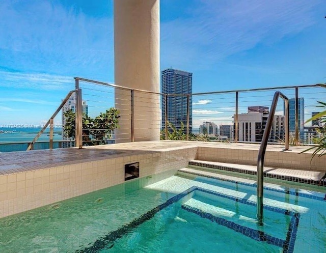 view of swimming pool with a water view