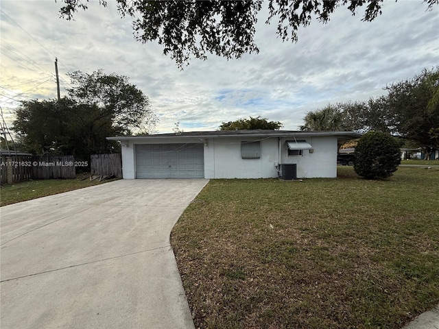 view of front of property featuring a garage, a front yard, and central air condition unit