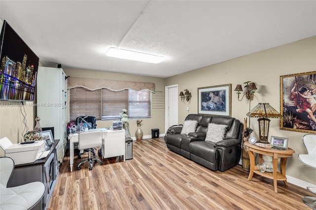 office area featuring light hardwood / wood-style floors and a textured ceiling