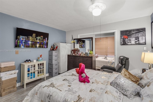 bedroom featuring ceiling fan and hardwood / wood-style floors