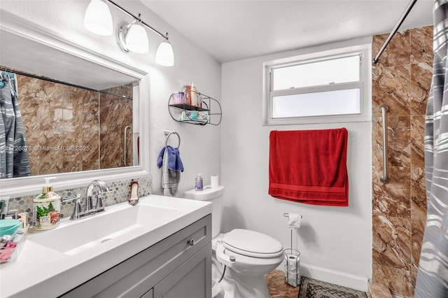 bathroom featuring toilet, walk in shower, and vanity