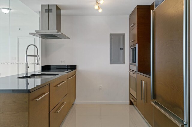 kitchen with sink, electric panel, extractor fan, and built in appliances