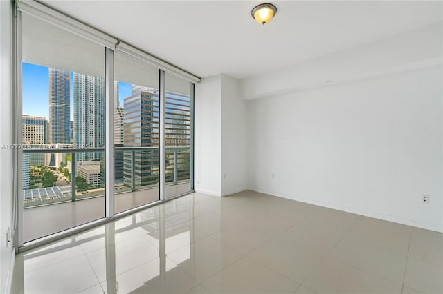 tiled spare room with floor to ceiling windows