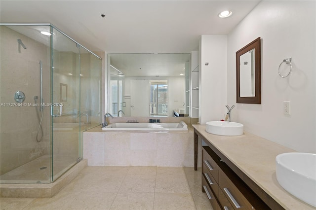 bathroom featuring tile patterned flooring, vanity, and shower with separate bathtub