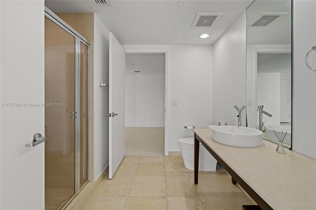 bathroom with an enclosed shower, tile patterned floors, vanity, and toilet