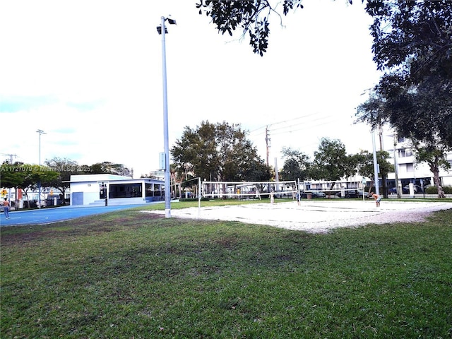 view of property's community featuring volleyball court and a yard