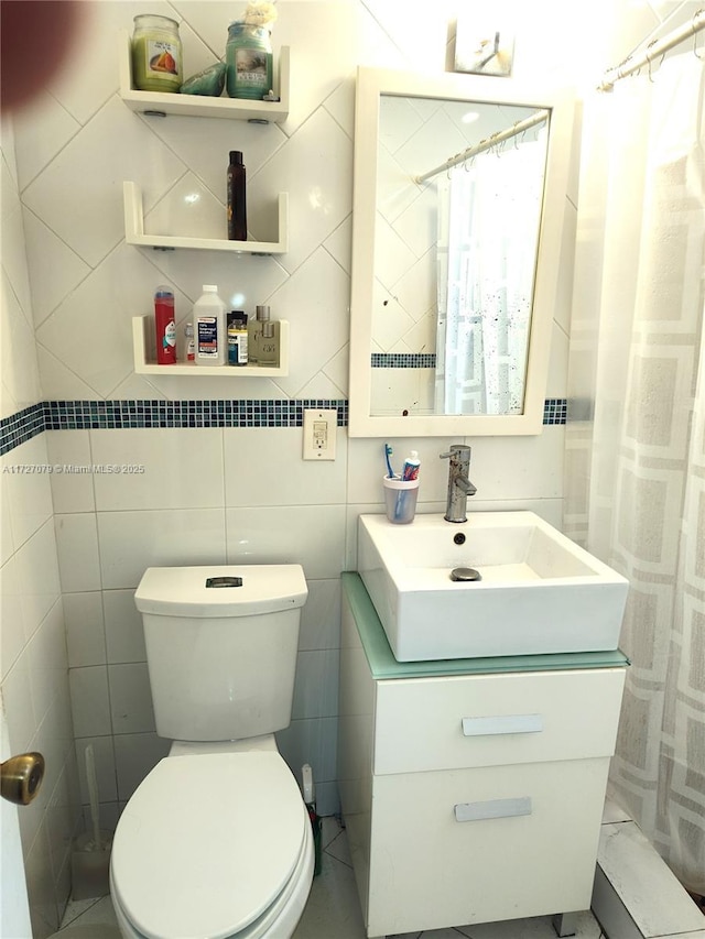 bathroom featuring toilet, tile walls, a shower with curtain, and vanity