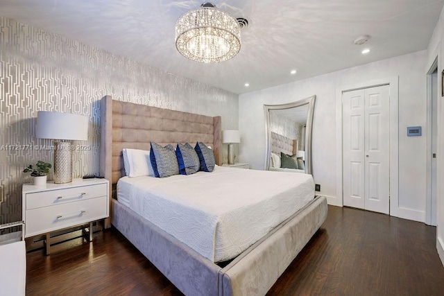 bedroom featuring dark hardwood / wood-style flooring and a chandelier