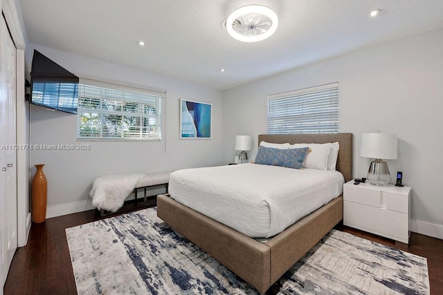 bedroom featuring dark hardwood / wood-style floors and multiple windows