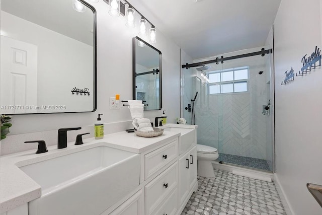 bathroom featuring toilet, a shower with door, and vanity